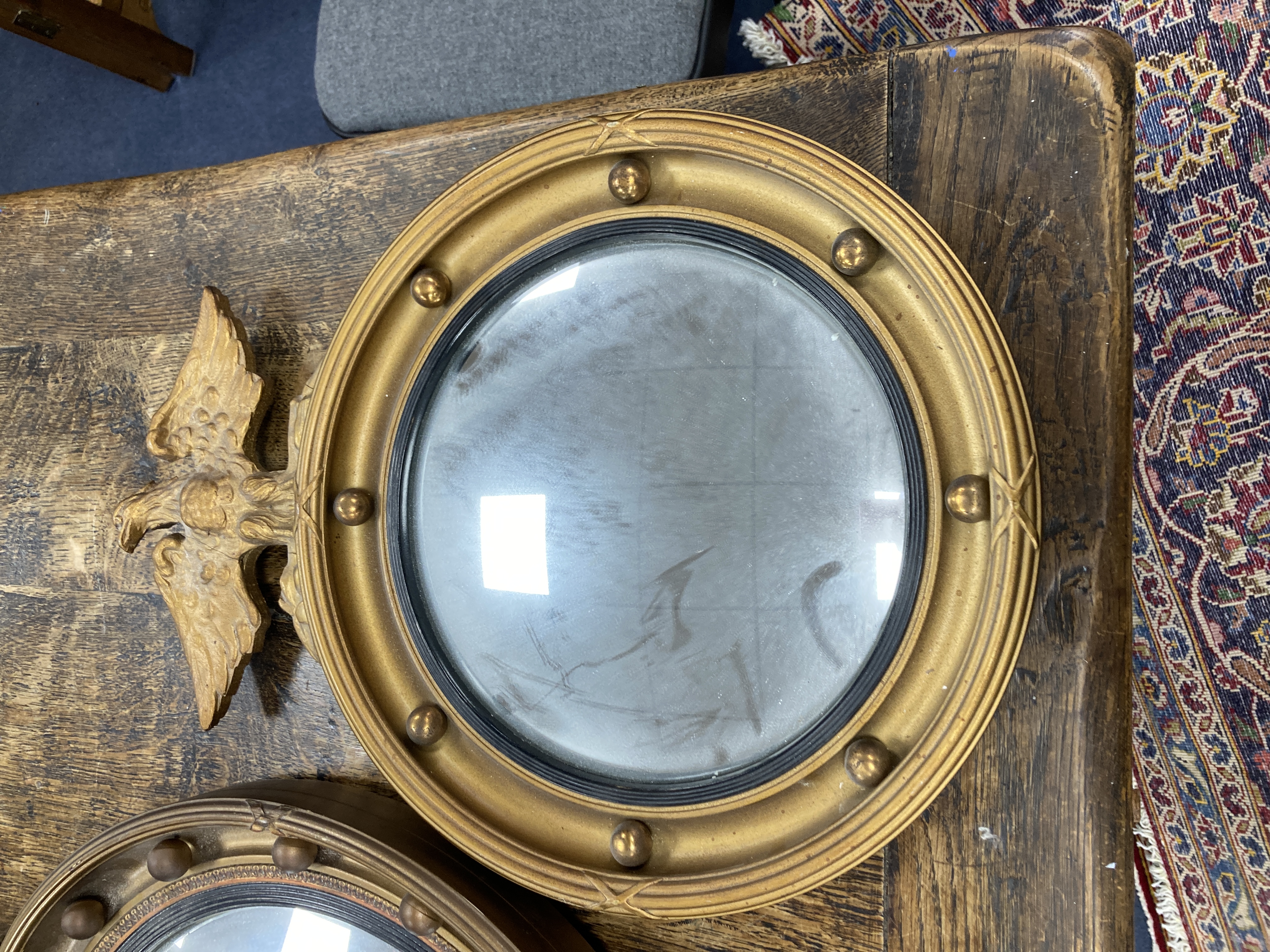 Two Regency style gilt-framed convex mirrors, larger 47cm diameter